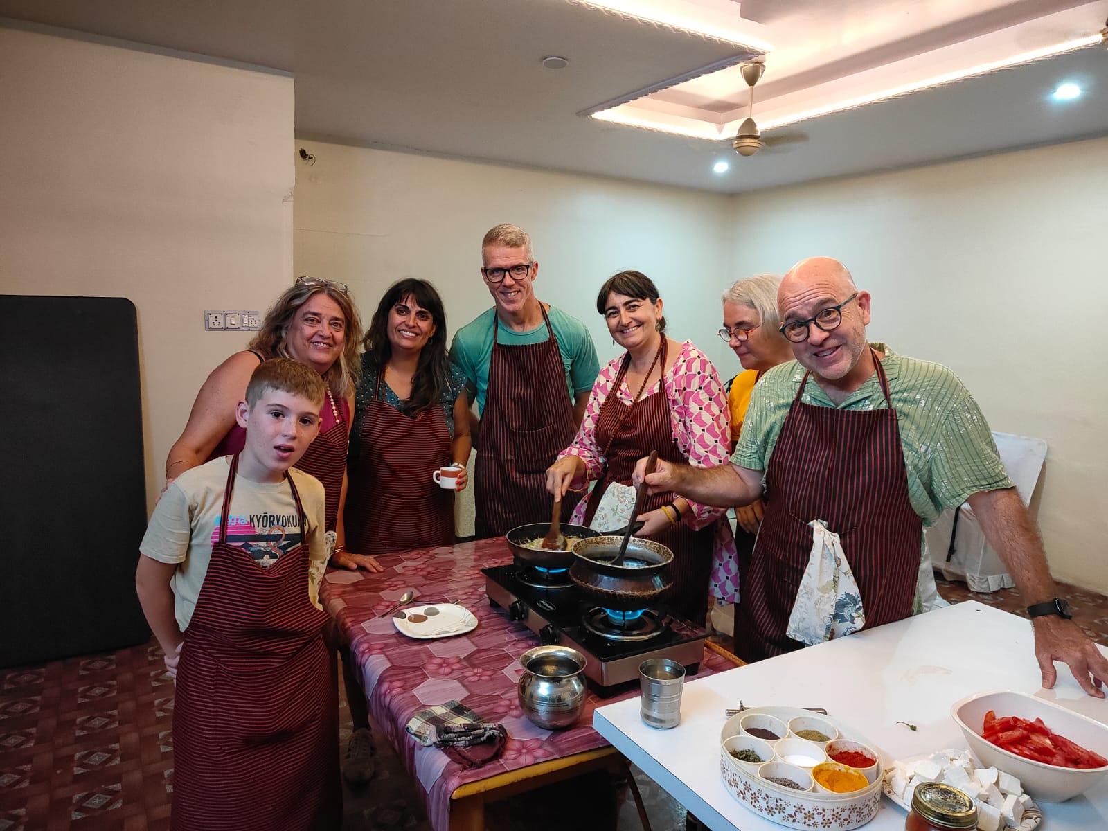 Guests posing in aprons before class